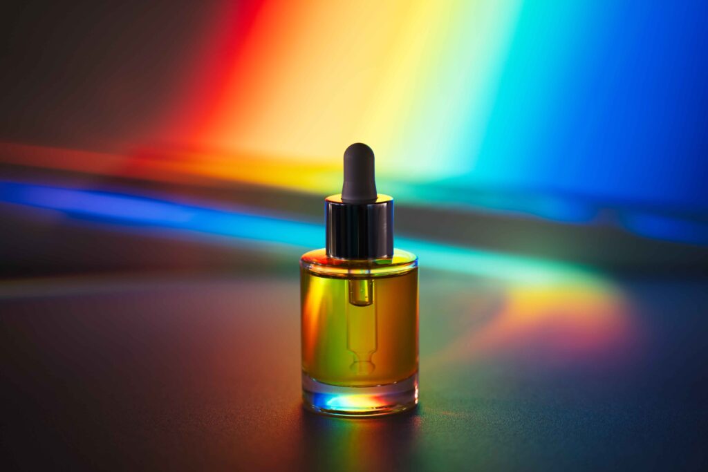 therapeutic oil in front of rainbow